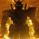 A giant Gundam robot, shadowed by fire, walks away downs a futuristic hall.